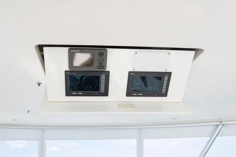 Slide: The Image of 2009 Viking 50 Convertible yacht dashboard with navigation and control displays. - 8