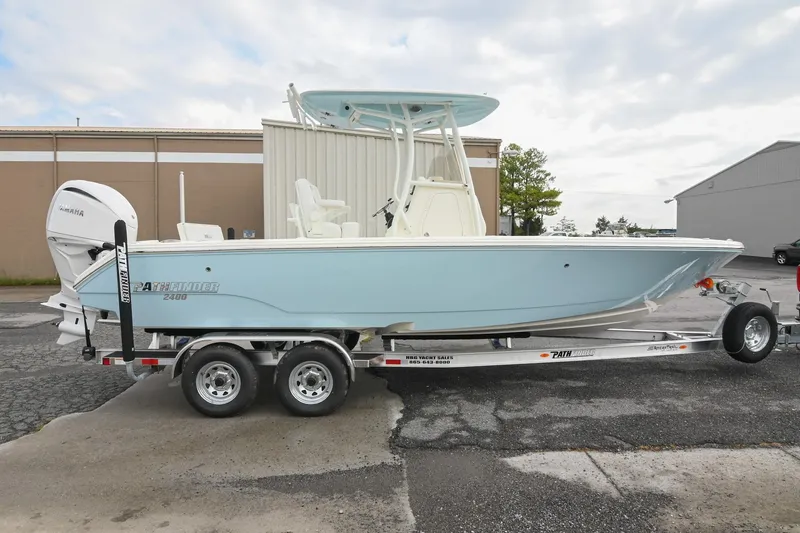 The Image of 2026 Pathfinder 2400 TRS boat on trailer, light blue hull, Yamaha engine, outdoor setting. - 0