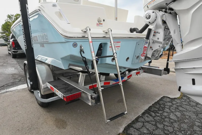 Slide: The Image of 2026 Pathfinder 2400 TRS boat on trailer with ladder and outboard motor. - 10