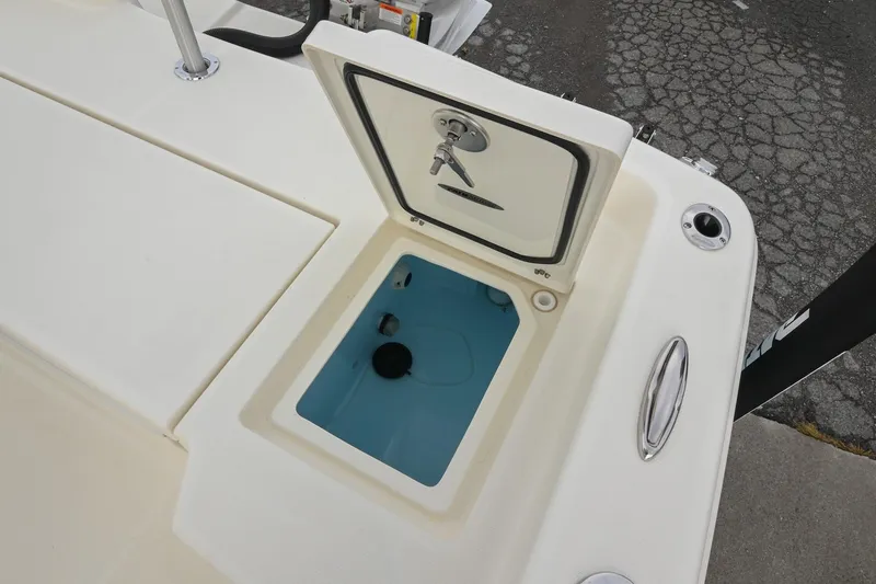 Slide: The Image of Open storage compartment on a 2026 Pathfinder 2400 TRS boat, showing interior details. - 16