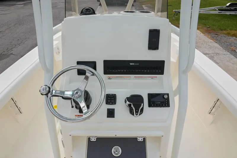 Slide: The Image of 2026 Pathfinder 2400 TRS boat console with steering wheel and controls. - 26