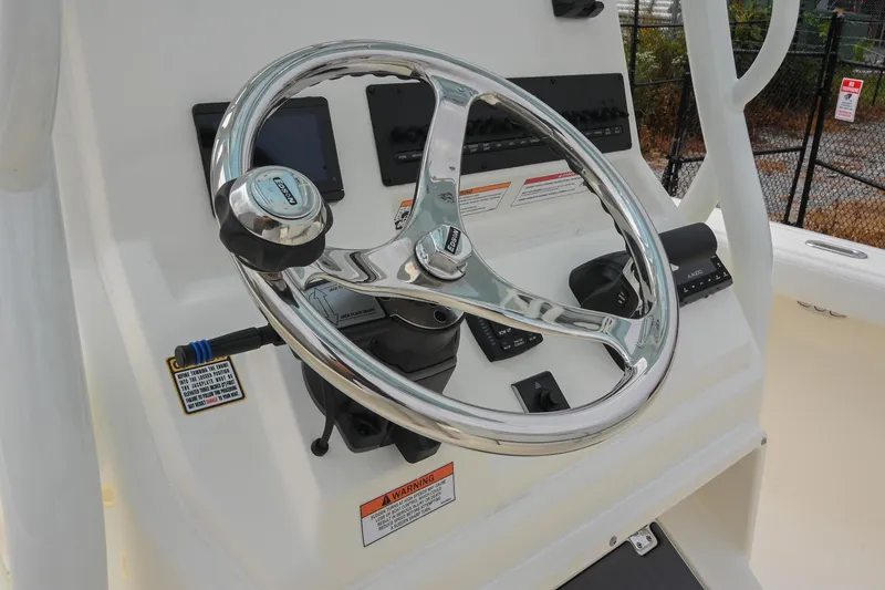 Slide: The Image of Steering console of 2026 Pathfinder 2400 TRS boat with chrome wheel and controls. - 29