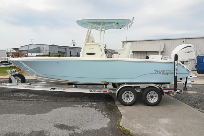 Slide: The Image of 2026 Pathfinder 2400 TRS boat on trailer, light blue hull, Yamaha engine, outdoor setting. - 3