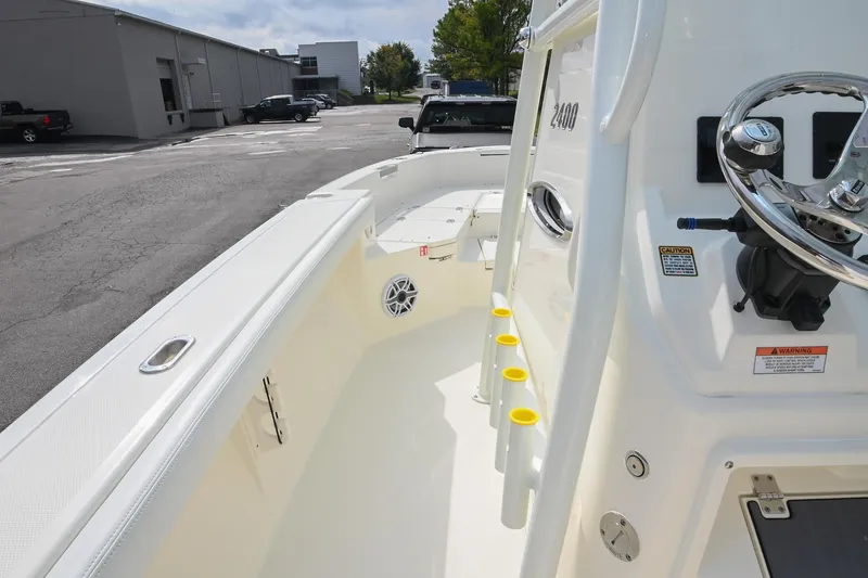 Slide: The Image of 2026 Pathfinder 2400 TRS boat interior with steering wheel and rod holders. - 32
