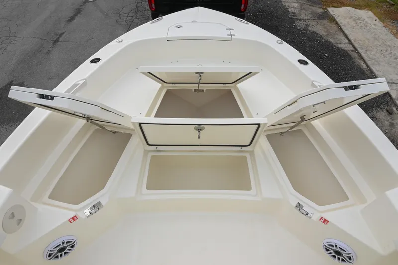 Slide: The Image of 2026 Pathfinder 2400 TRS boat with open storage compartments on deck. - 35