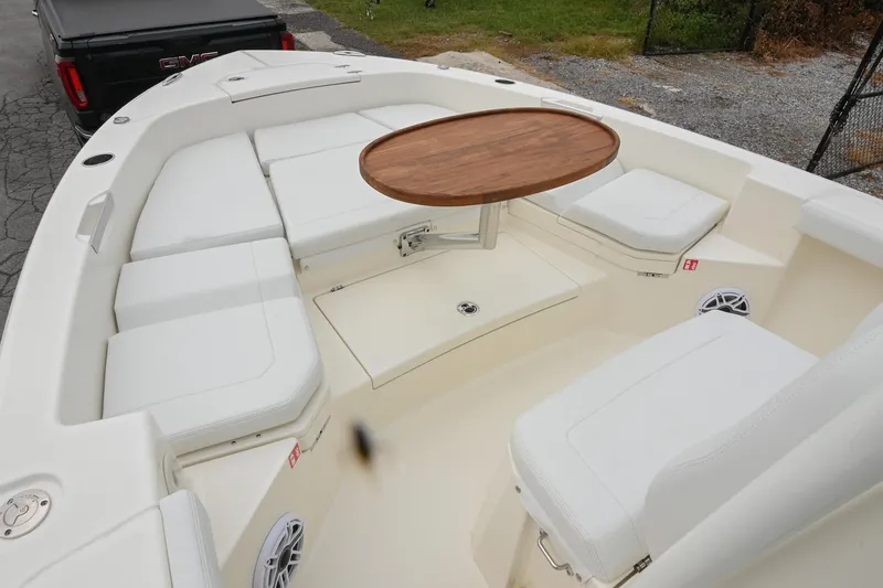 Slide: The Image of 2026 Pathfinder 2400 TRS boat interior with white seating and wooden table. - 36