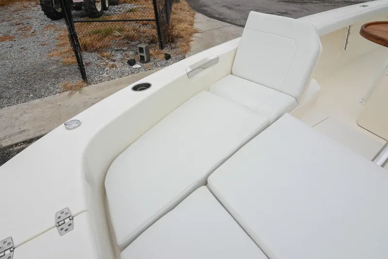 Slide: The Image of 2026 Pathfinder 2400 TRS boat interior with white cushioned seating. - 39