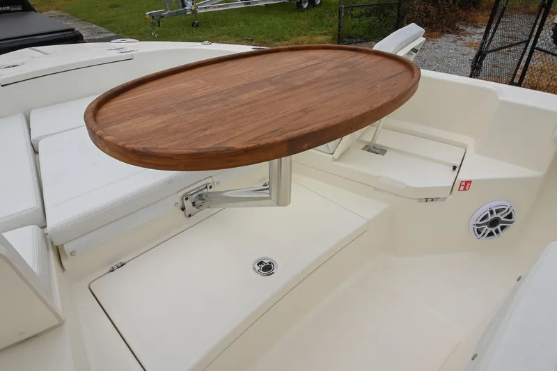 Slide: The Image of 2026 Pathfinder 2400 TRS boat interior with wooden table and white seating. - 41
