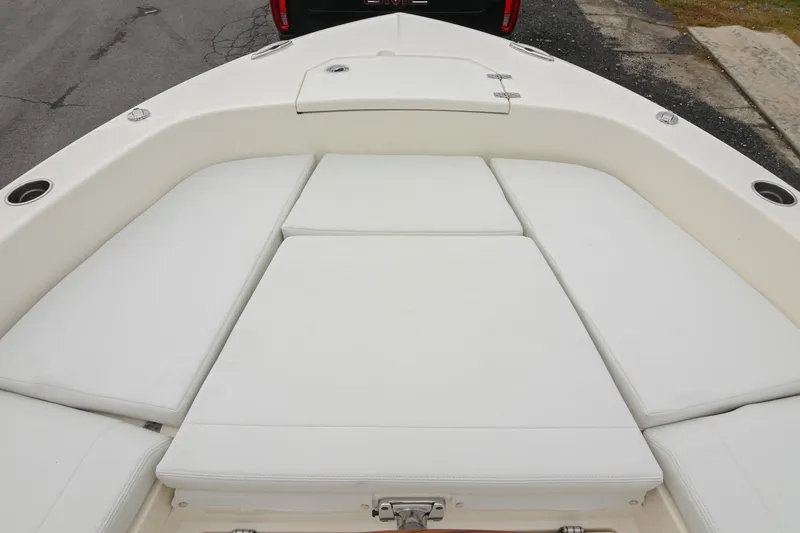 Slide: The Image of 2026 Pathfinder 2400 TRS boat with cushioned seating and storage compartment. - 42