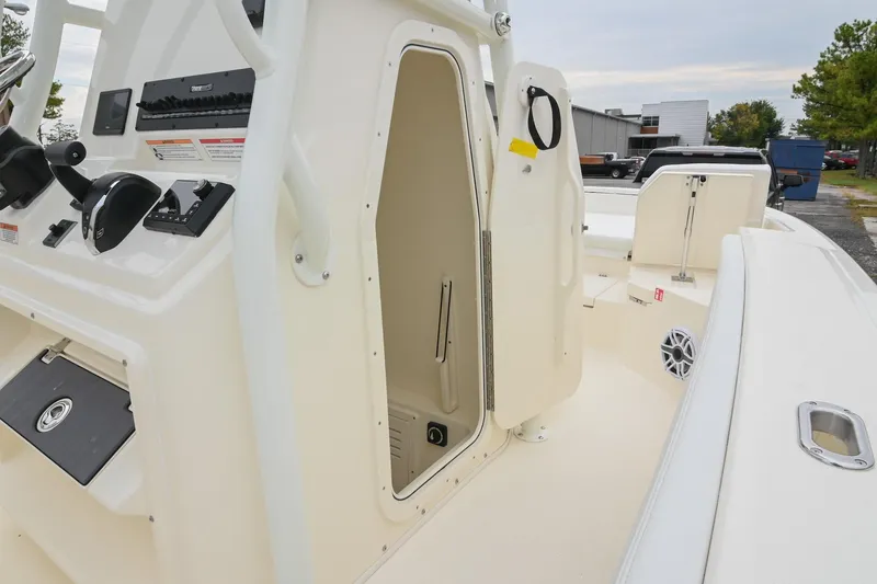 Slide: The Image of 2026 Pathfinder 2400 TRS boat interior with open console door and control panel. - 43