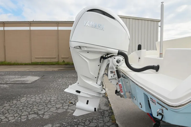 Slide: The Image of 2026 Pathfinder 2400 TRS boat with Yamaha outboard motor, parked on concrete surface. - 8