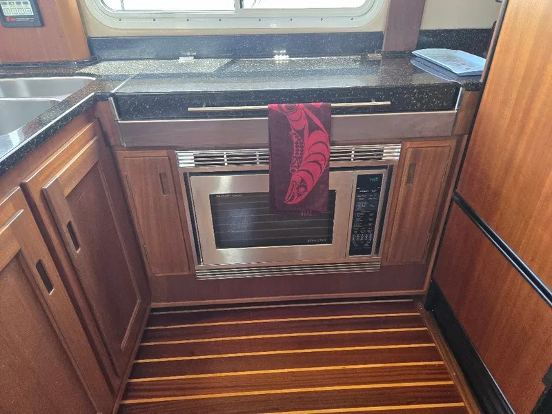 Slide: The Image of Stainless steel two-burner stove in 2010 American Tug 49 Limited yacht kitchen. - 24