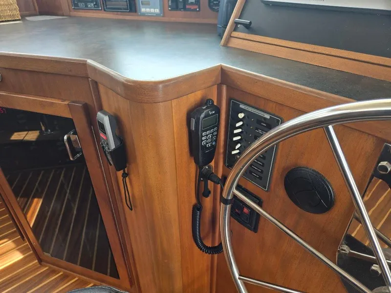 Slide: The Image of Control panel and steering wheel of a 2010 American Tug 49 Limited boat. - 43