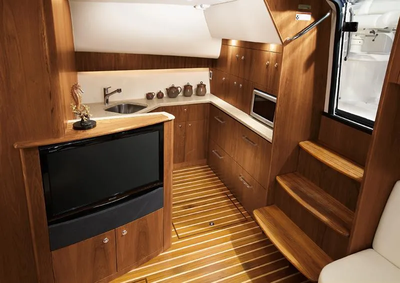 Slide: The Image of Manufacturer Provided Image: 2016 Tiara Yachts 4300 Open interior with wooden cabinetry and modern amenities. - 11