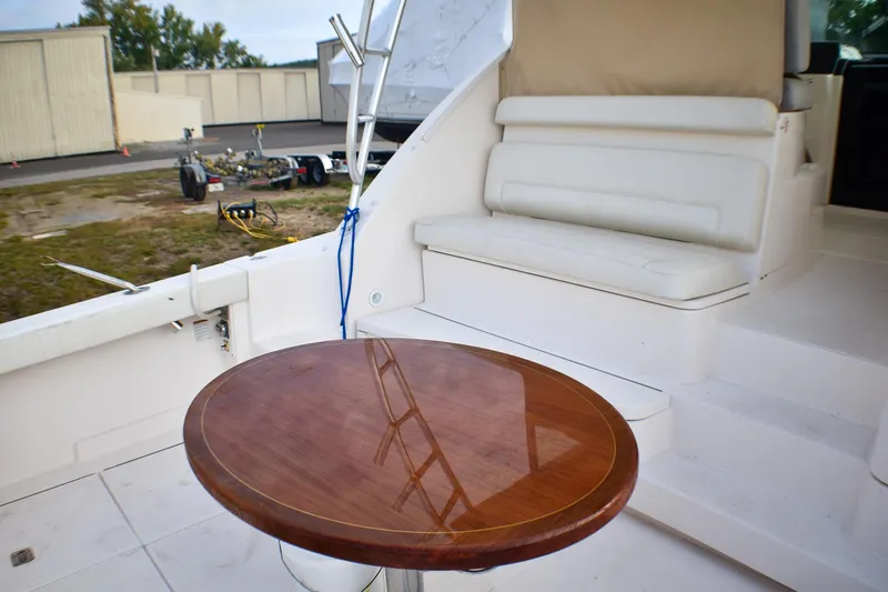 Slide: The Image of 2016 Tiara Yachts 4300 Open interior with wooden table and white seating. - 17