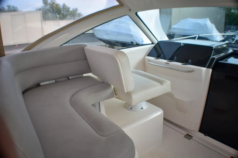 Slide: The Image of 2016 Tiara Yachts 4300 Open interior with white seating and helm station. - 20