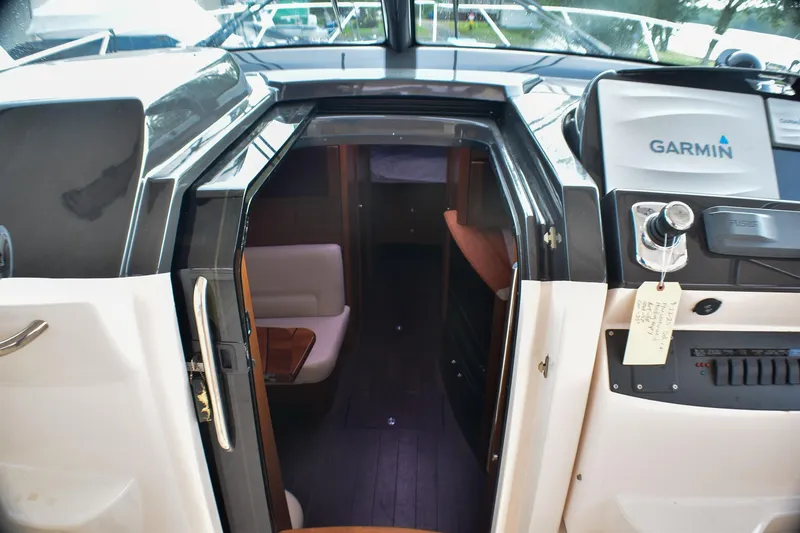 Slide: The Image of 2016 Tiara Yachts 4300 Open interior with Garmin navigation system and cozy seating area. - 25