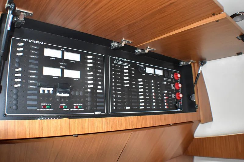Slide: The Image of Electrical control panel on a 2016 Tiara Yachts 4300 Open, featuring AC and DC systems. - 28