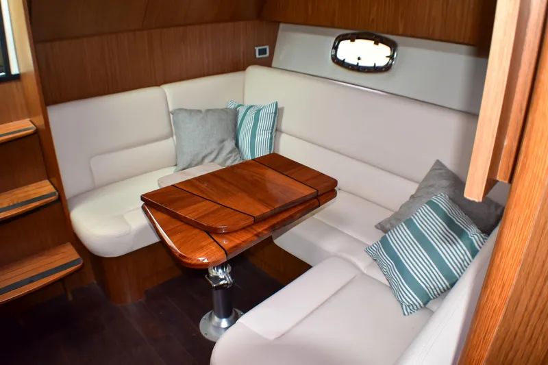 Slide: The Image of Luxurious interior of 2016 Tiara Yachts 4300 Open with plush seating and wooden table. - 29