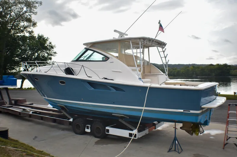 Slide: The Image of 2016 Tiara Yachts 4300 Open on trailer by waterfront, showcasing sleek design. - 3