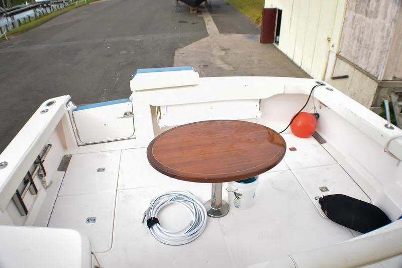 Slide: The Image of 2016 Tiara Yachts 4300 Open deck with wooden table and marine equipment. - 30