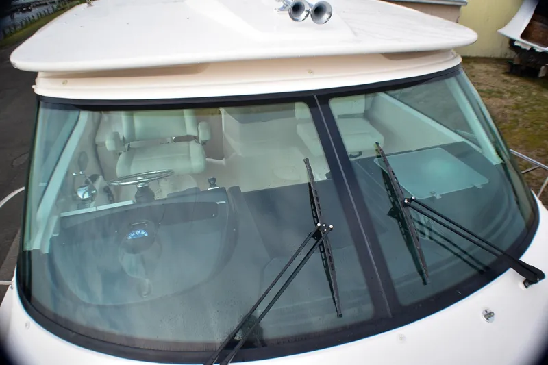 Slide: The Image of 2016 Tiara Yachts 4300 Open cockpit view with windshield wipers and steering wheel. - 34