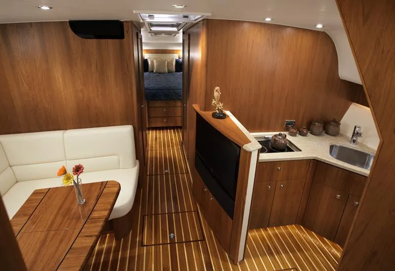 Slide: The Image of Manufacturer Provided Image: 2016 Tiara Yachts 4300 Open interior with wood finish, dining area, and kitchenette. - 9