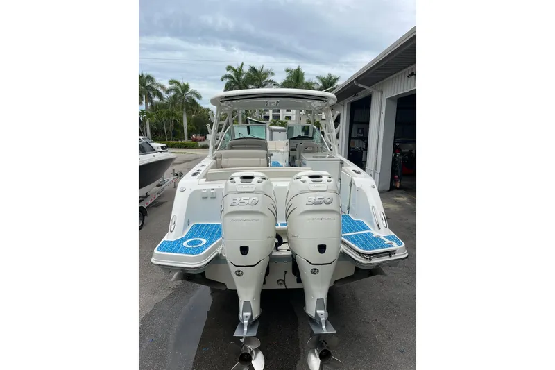 Slide: The Image of 2017 Boston Whaler 320 Vantage boat with twin 350 horsepower engines, docked outdoors. - 10