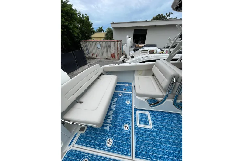 Slide: The Image of 2017 Boston Whaler 320 Vantage boat interior with blue deck and white seating. - 14