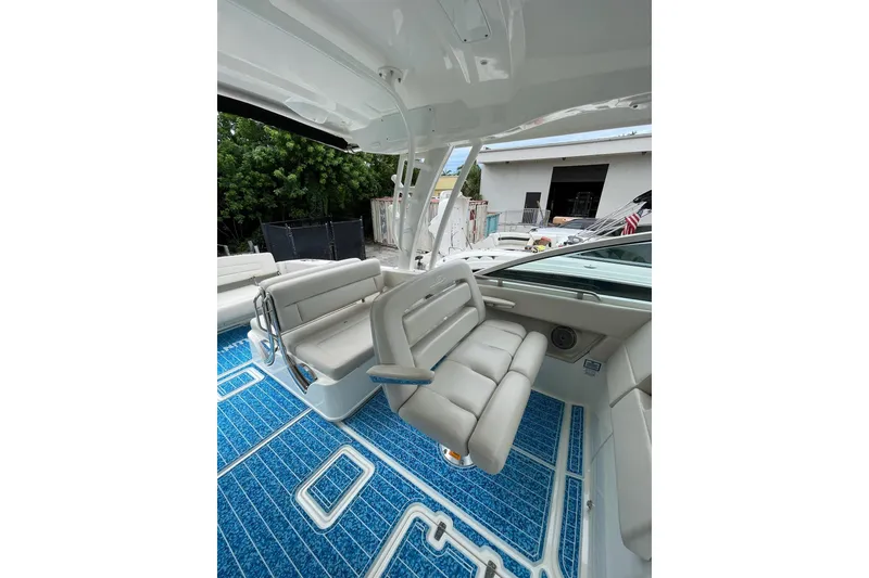 Slide: The Image of 2017 Boston Whaler 320 Vantage interior with blue flooring and comfortable seating. - 16