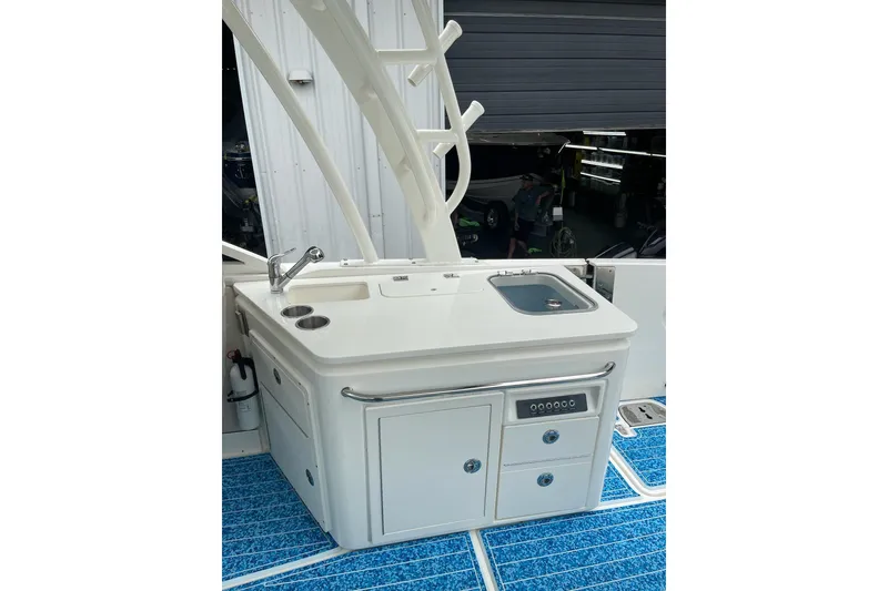Slide: The Image of 2017 Boston Whaler 320 Vantage boat interior with sink and storage area. - 17