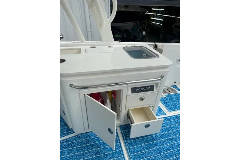 Slide: The Image of 2017 Boston Whaler 320 Vantage boat interior with storage compartments and sink. - 18