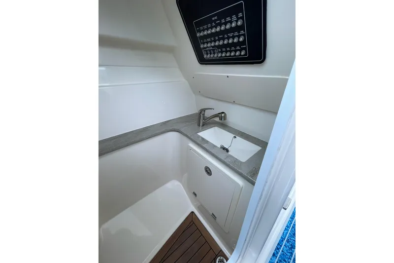 Slide: The Image of 2017 Boston Whaler 320 Vantage interior with sink and control panel. - 21