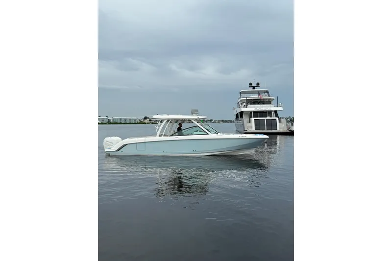 Slide: The Image of 2017 Boston Whaler 320 Vantage boat on calm water, overcast sky. - 25