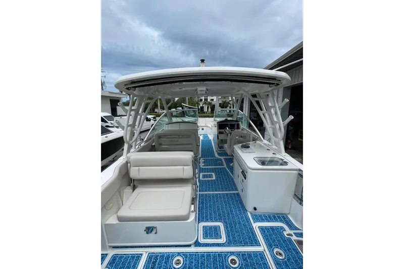 Slide: The Image of 2017 Boston Whaler 320 Vantage boat interior with blue flooring and seating. - 29