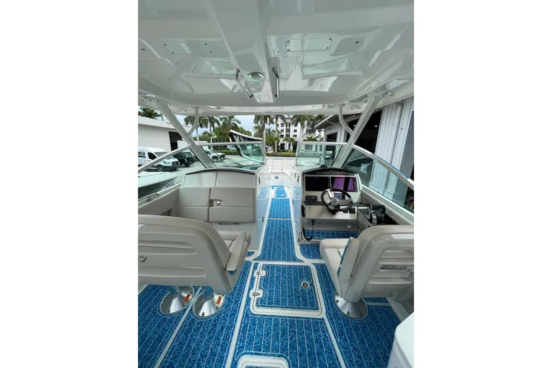 Slide: The Image of 2017 Boston Whaler 320 Vantage boat interior with blue flooring and modern helm. - 31