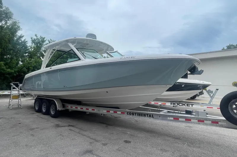 Slide: The Image of 2017 Boston Whaler 320 Vantage on trailer, parked outdoors, overcast sky. - 4