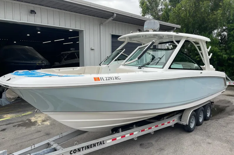 Slide: The Image of 2017 Boston Whaler 320 Vantage boat on trailer near storage facility. - 7