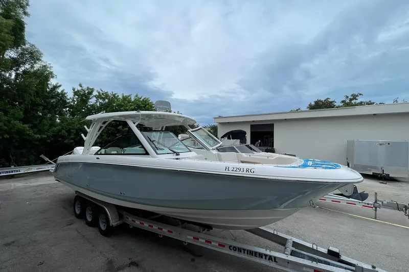 Slide: The Image of 2017 Boston Whaler 320 Vantage boat on trailer, parked outdoors. - 8