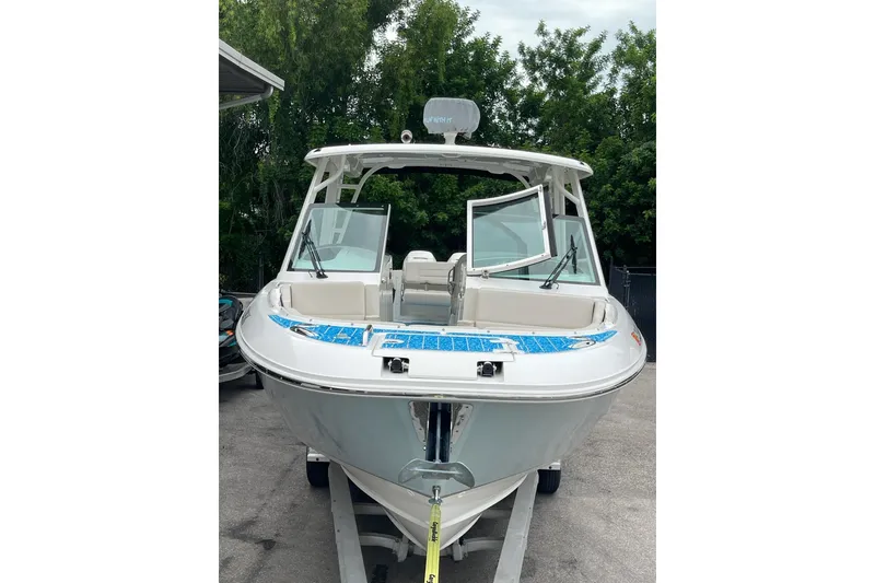 Slide: The Image of 2017 Boston Whaler 320 Vantage boat on trailer, front view, surrounded by trees. - 9