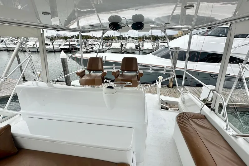 Slide: The Image of Custom Carolina Precision Sportfish 2000 boat interior with leather seating and marina view. - 13
