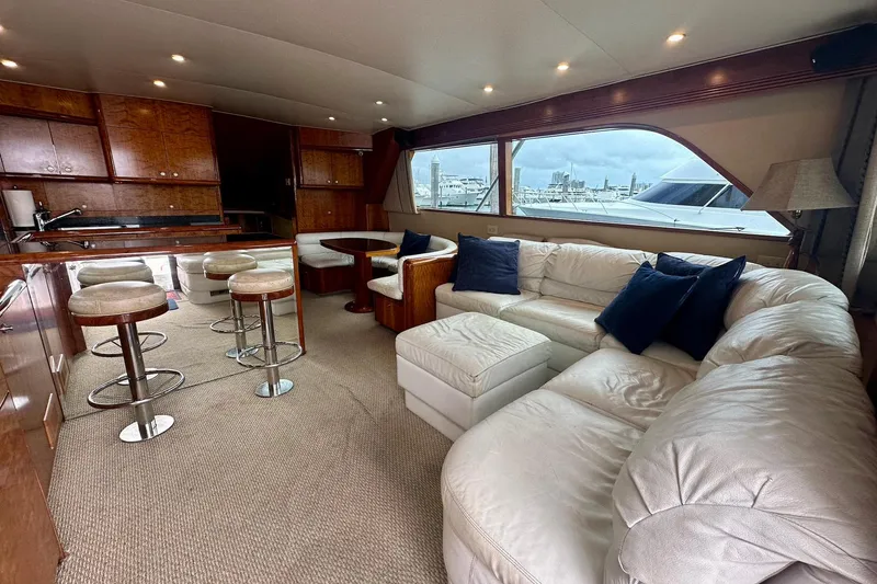 Slide: The Image of Luxurious interior of 2000 Custom Carolina Precision Sportfish yacht with plush seating and bar stools. - 16