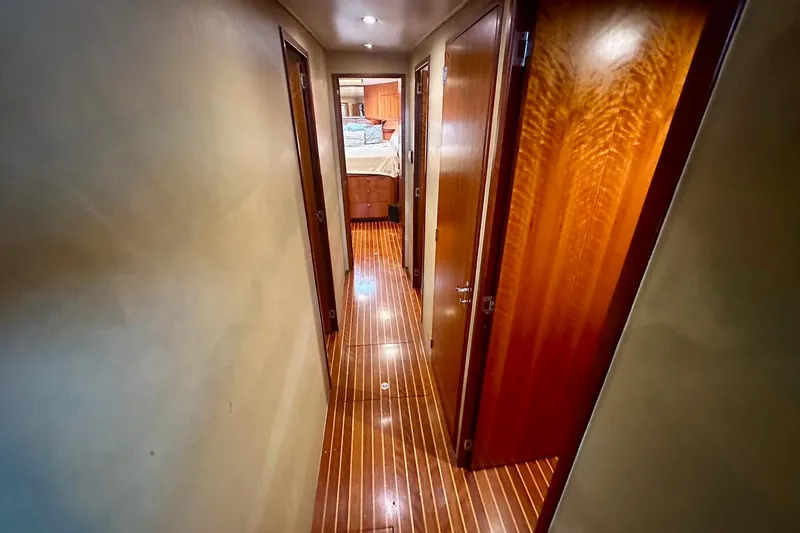 Slide: The Image of Hallway inside 2000 Custom Carolina Precision Sportfish yacht with wooden flooring and doors. - 21