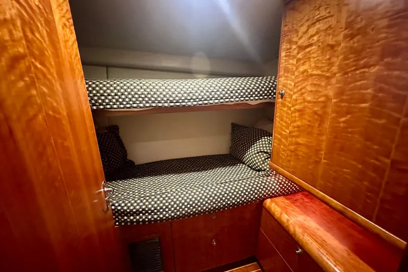 Slide: The Image of Interior of 2000 Custom Carolina Precision Sportfish with wooden bunk beds and checkered bedding. - 22