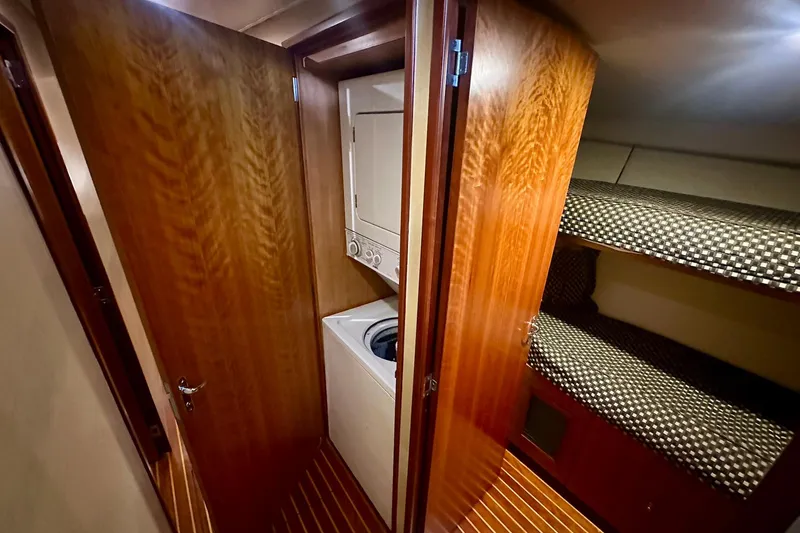 Slide: The Image of Laundry area and bunk beds in 2000 Custom Carolina Precision Sportfish yacht interior. - 23