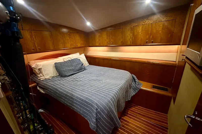 Slide: The Image of Luxurious cabin interior of 2000 Custom Carolina Precision Sportfish with wood paneling and cozy bedding. - 24
