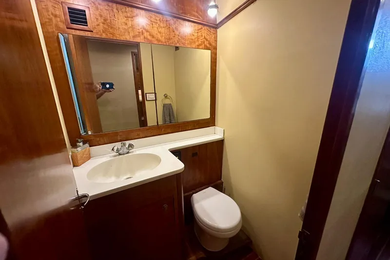 Slide: The Image of Bathroom interior of 2000 Custom Carolina Precision Sportfish yacht, featuring sink and toilet. - 26