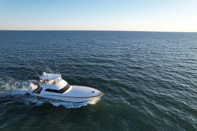 Slide: The Image of Custom Carolina Precision Sportfish 2000 cruising on open sea under clear sky. - 31
