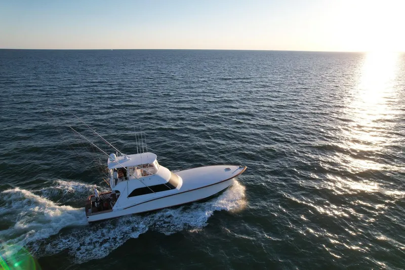 Slide: The Image of Custom Carolina Precision Sportfish 2000 cruising on open sea at sunset. - 32