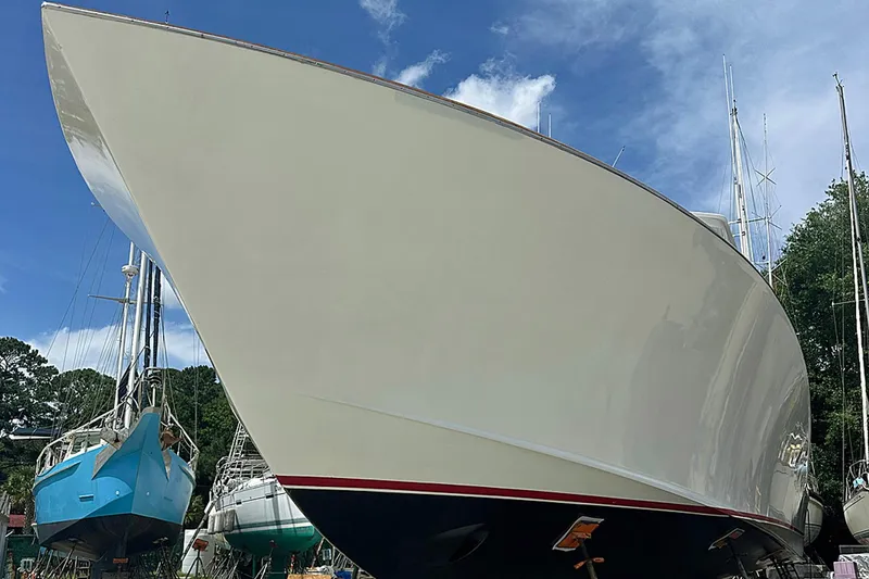 Slide: The Image of 2000 Custom Carolina Precision Sportfish boat on land, with clear blue sky background. - 33